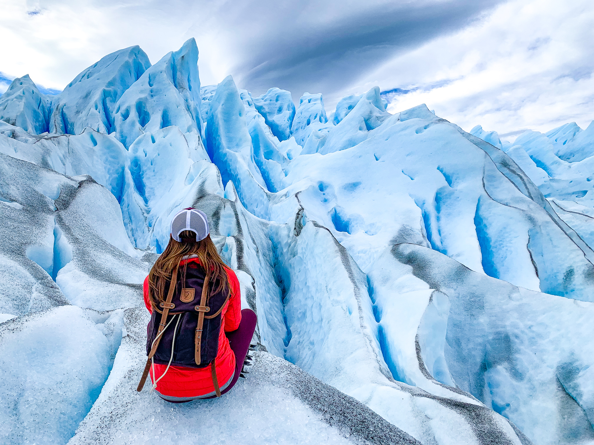 A massive blue-white glacier towering over a lake in Patagonia